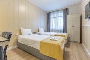 a hotel room with two beds and a window at Hotel Atabay in Istanbul +40 photos