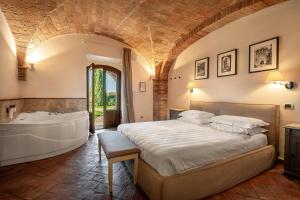 a bedroom with a large bed and a bath tub at Mormoraia in San Gimignano +277 photos