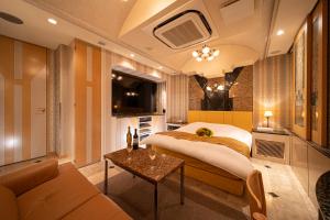 a hotel room with a bed and a couch at Lucky Sun in Nishinomiya
