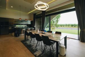 a kitchen and dining room with a table and chairs at Porsampao Luxury Villa in Ban Khok Khilek