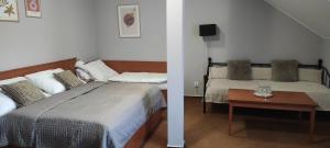 a bedroom with two beds and a table in it at Penzion Siesta in Valtice
