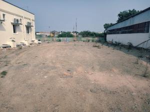 an empty dirt field next to a building at AalaGo in Thiruchendur