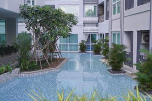 a swimming pool in the middle of a building at Deco Harmony Pattaya 1 in North Pattaya