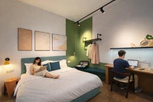 a man and a woman sitting on a bed in a room at Faloe Hostel in Kota Kinabalu +54 photos