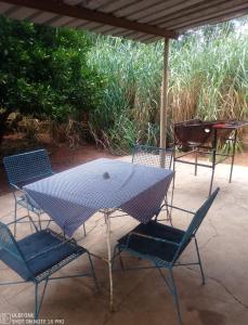 a table and chairs and a grill on a patio at Hippo Farm Apartment in Gobabis