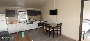 a kitchen with a table and chairs in a room at Villa Nikitas Beach in Agios Nikitas +15 photos