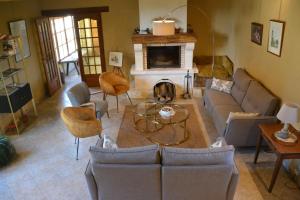 a living room with a couch and a fireplace at Château de Ribourdin in Chevannes