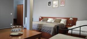 a bedroom with a bed and a table with glasses on it at Penzion Siesta in Valtice +57 photos