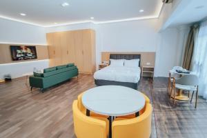 a hotel room with a bed and a couch and a table at Hotel Koperasi in Seria