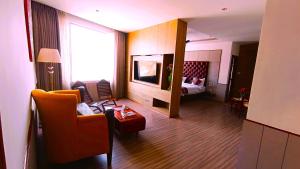 a living room with a couch and a bed at Hotel k11 in Solan