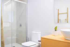 a bathroom with a shower and a toilet and a sink at Luxury Villa Lumina with Arcade & Pool Table, PS5 in Can Picafort
