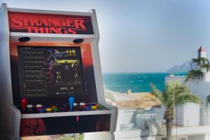 a stranger things ticket machine in front of a building at Luxury Villa Lumina with Arcade & Pool Table, PS5 in Can Picafort