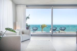a living room with a view of the ocean at Luxury Villa Lumina with Arcade & Pool Table, PS5 in Can Picafort +77 photos