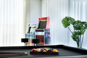 a table with a game console and a pile of balls at Luxury Villa Lumina with Arcade & Pool Table, PS5 in Can Picafort