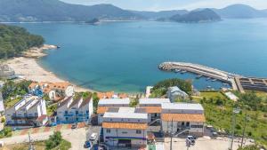 an aerial view of a town next to a body of water at Geoje Badageurigo Pension in Geoje