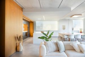 a living room with a white couch and a table at Luxury Villa Lumina with Arcade & Pool Table, PS5 in Can Picafort