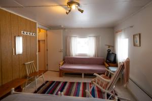 a living room with a bed and a couch at Heidin Mummola Farm in Turtola