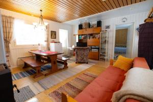 a living room with a couch and a table at Heidin Mummola Farm in Turtola