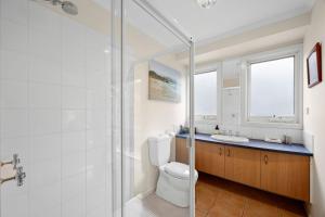 a bathroom with a shower and a toilet and a sink at Salty Haven in Moggs Creek +18 photos