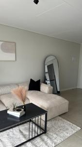 a living room with a couch and a table at Elara in Sandton +16 photos