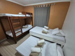 a small room with two bunk beds and a ladder at Door207 Homestay in Baguio