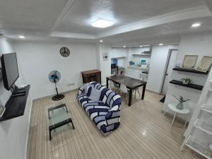 a living room with a couch and a table at Door207 Homestay in Baguio