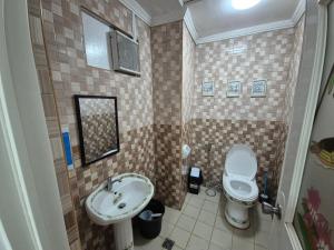 a small bathroom with a sink and a toilet at Door207 Homestay in Baguio +2 photos