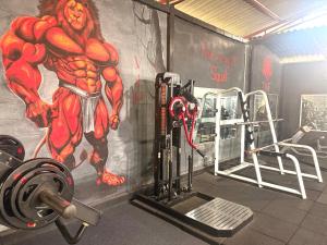 a gym with a superhero painted on the wall at Chill Tangalle in Tangalle