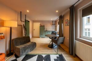 a living room with a couch and a table at Hotel Riche in Valkenburg +51 photos