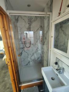 a bathroom with a shower and a sink at Bumble Bee Cabin in Bootle