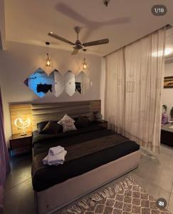 a bedroom with a bed with umbrellas on the wall at Noida Stay with Yamuna View in Noida