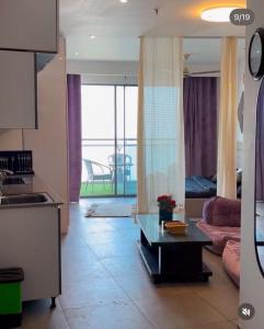 a kitchen and living room with a couch and a table at Noida Stay with Yamuna View in Noida