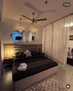 a bedroom with a bed with umbrellas on the wall at Noida Stay with Yamuna View in Noida