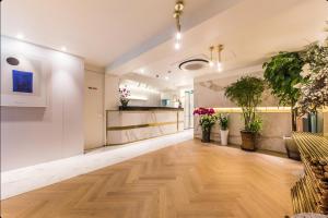 an empty lobby with potted plants on the walls at STYLE Hotel in Seoul