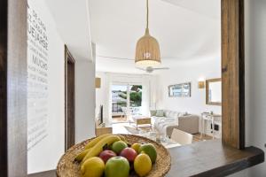 a bowl of fruit on a table in a living room at MY ALVA PARK - 50m from the beach in Lloret de Mar