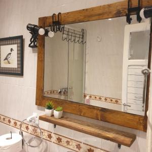 a bathroom with a mirror and a sink at Casita de Aldea in Sotrondio +29 photos