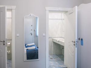 a bathroom with a shower and a sink and a mirror at Family Hotel Belle Epoque Beach in Varna City