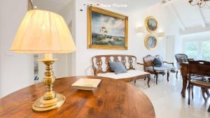 a living room with a table with a lamp on it at La Galleria del Tempo, Terre Marine in Portovenere
