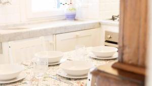 a kitchen with plates and bowls on a table at La Galleria del Tempo, Terre Marine in Portovenere +14 photos