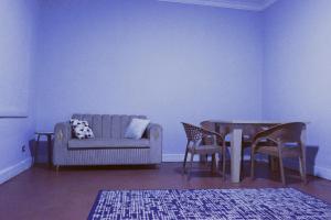 a living room with a couch and a table and chairs at Downtown Lucky Apartment in Cairo