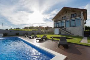 a villa with a swimming pool and a house at Private Vineyard Villa with Heated Pool, Spa & BBQ by Destination GREEN Croatia in Velika