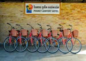 a group of bikes parked next to a brick wall at Phuket Airport Hotel in Nai Yang Beach