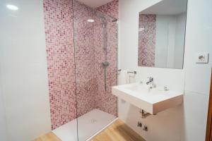 a bathroom with a sink and a shower at Hostal Cortés in Cuenca +44 photos