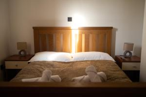 a bedroom with a bed with white towels on it at Private Vineyard Villa with Heated Pool, Spa & BBQ by Destination GREEN Croatia in Velika +18 photos