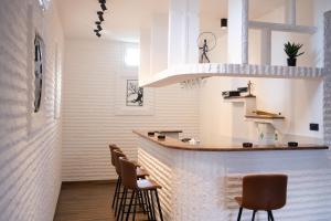 a bar in a room with chairs and a counter at Private Vineyard Villa with Heated Pool, Spa & BBQ by Destination GREEN Croatia in Velika
