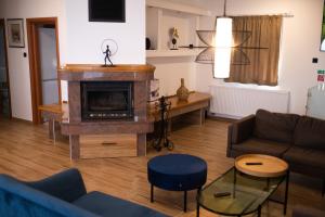 a living room with a couch and a fireplace at Private Vineyard Villa with Heated Pool, Spa & BBQ by Destination GREEN Croatia in Velika