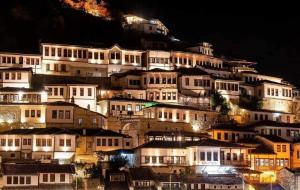 a bunch of buildings on a hill at night at Oda e Vjetër in Berat