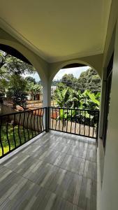 an empty balcony with a view of trees at Karibu Resort Sipi in Kapchorwa