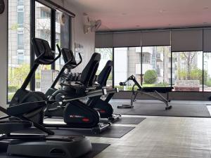 a gym with treadmills and elliptical machines at Bann-Kun Impact Muang Thong 2BR Condo Wi-Fi MRT Pink Near Airport DM in Nonthaburi