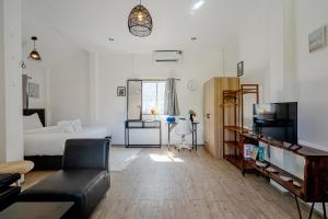 a living room with a bed and a couch at Beachfront Villa with Sunset in Ban Bang Po